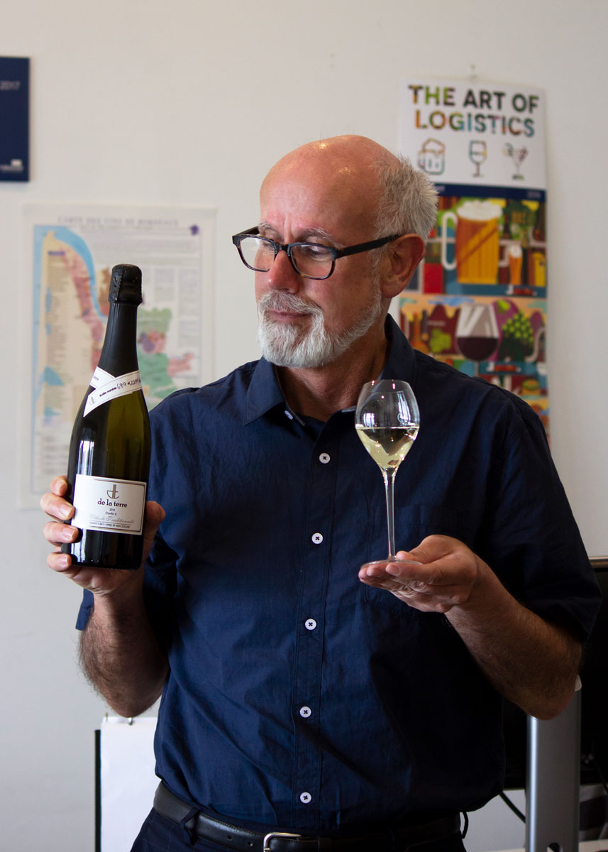 Man holding wine glass and bottle